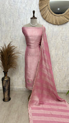 Pink saree with a mannequin against a neutral wall.