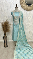 Light blue saree with silver embroidery on a mannequin against a neutral wall.