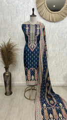 Navy blue embroidered traditional outfit with a matching dupatta on a mannequin against a neutral wall.