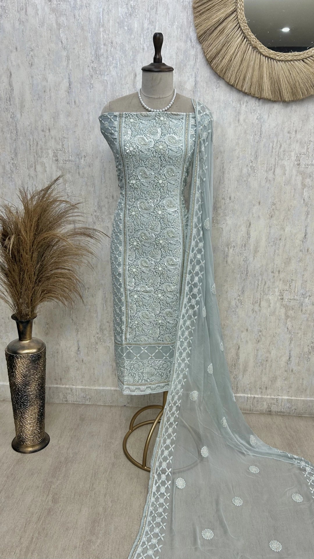 “Soft pastel blue georgette unstitched suit set with white embroidery and pearl detailing, paired with matching sheer dupatta on mannequin.”